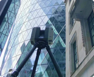 A high-tech 3D laser scanner set up on a tripod, capturing precise building data for analysis