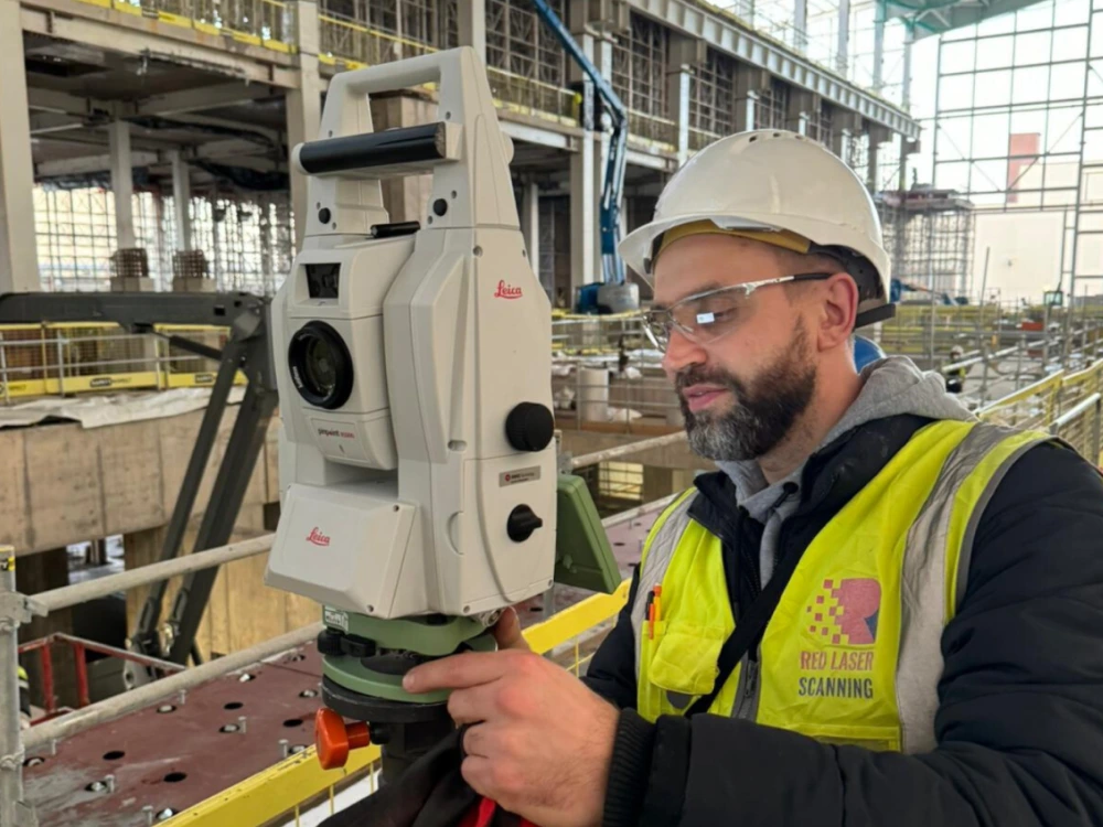 Construction verification in progress with a total station, capturing accurate data for alignment and measurement checks