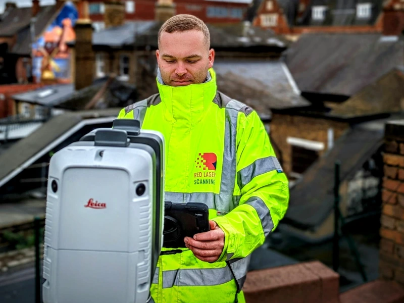 A surveyor with a laser scanner, capturing detailed data for producing accurate CAD drawings of the site