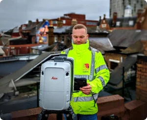 An expert using advanced equipment to perform a precise measured survey on a rooftop