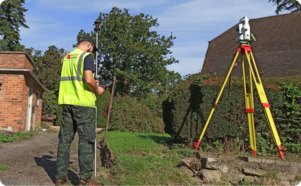 Surveyor using GPS and total station to conduct boundary surveying