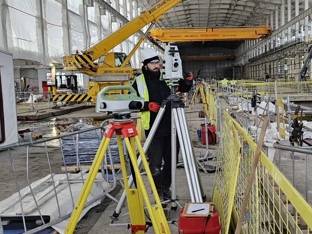 Surveyor using advanced equipment for monitoring surveying, ensuring precise structural analysis