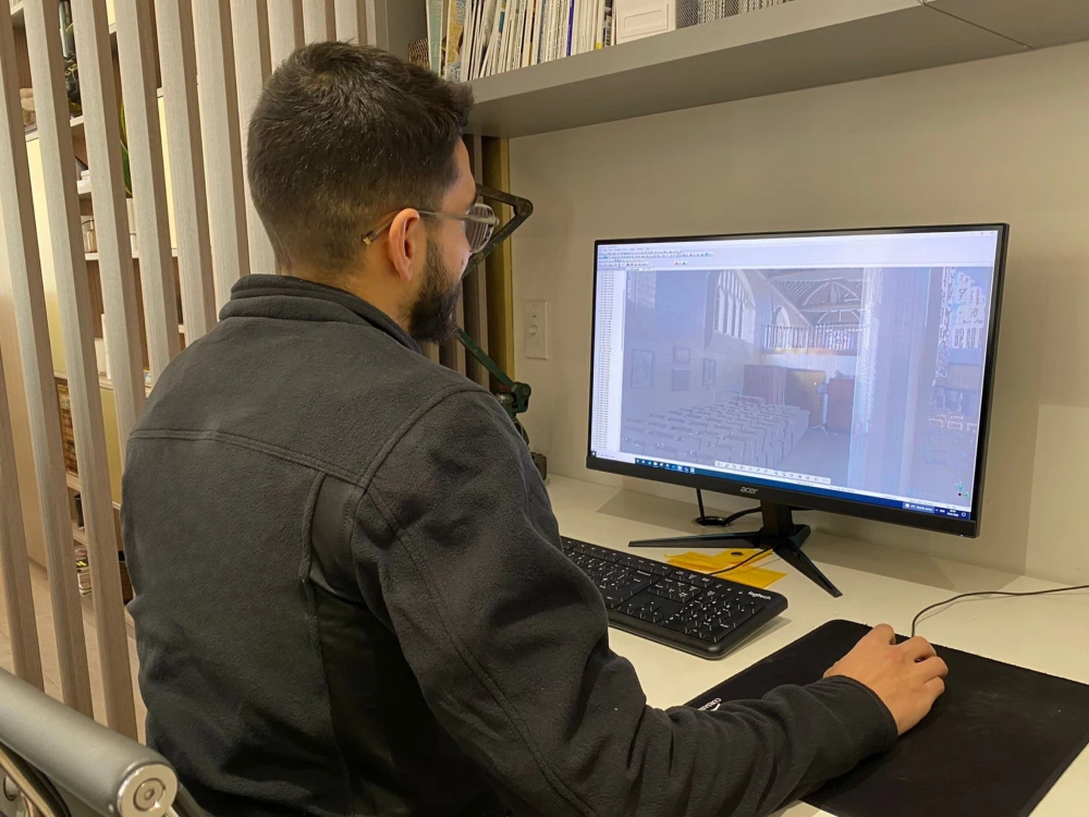 Red Laser technician working on computer to produce accurate 3D modelling